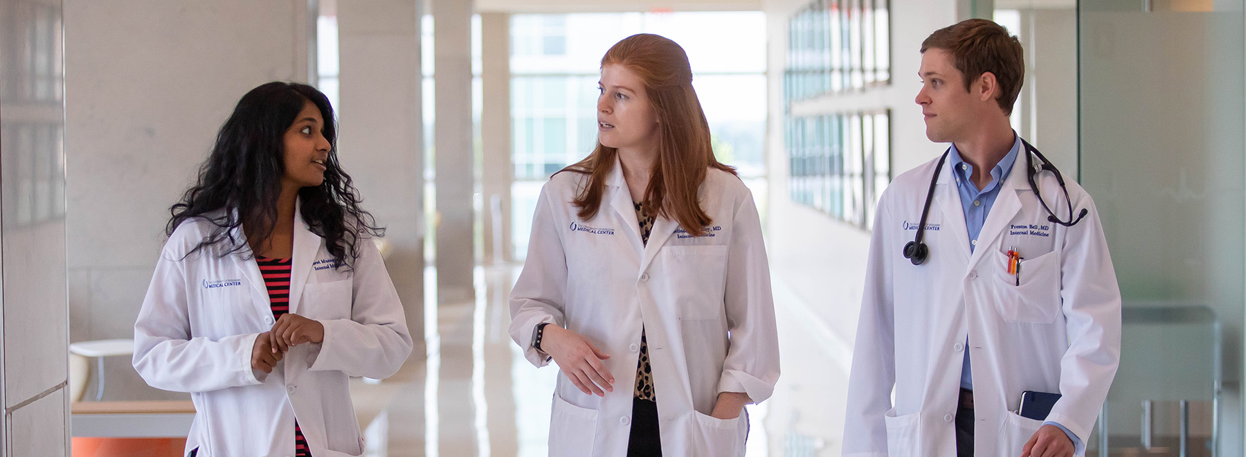 Residents walk down a UMMC hallway Residents walk down a UMMC hallway